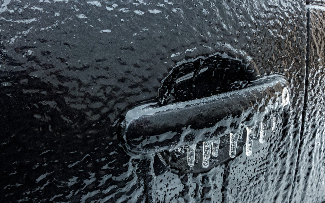 Icy rain on a black car. Frozen car.