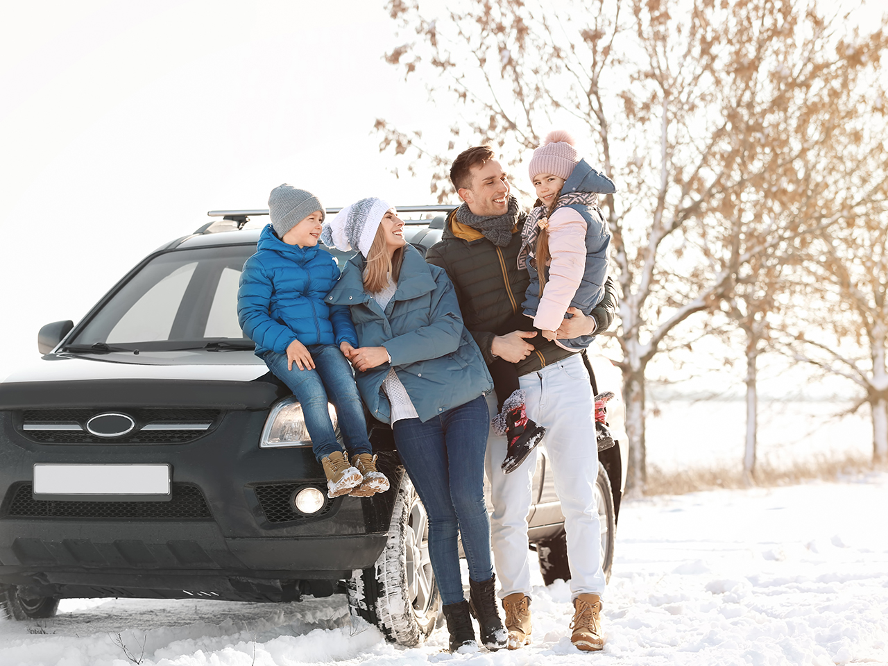 Happy family near car on winter day